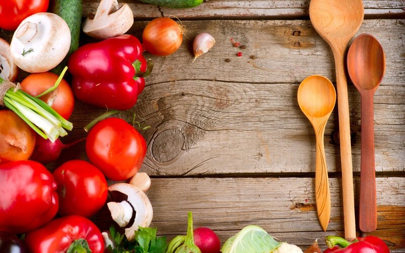 Fresh vegetables and wooden spoons