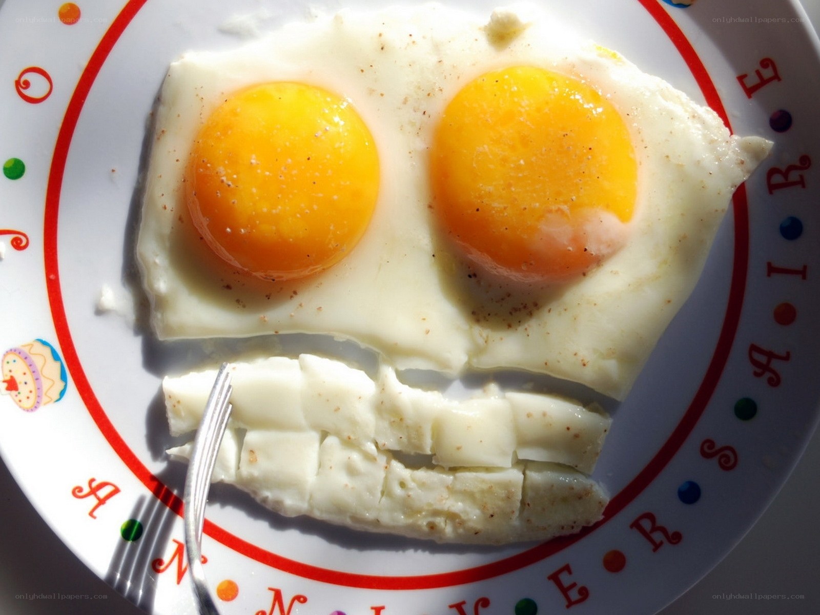fried eggs face on a plate