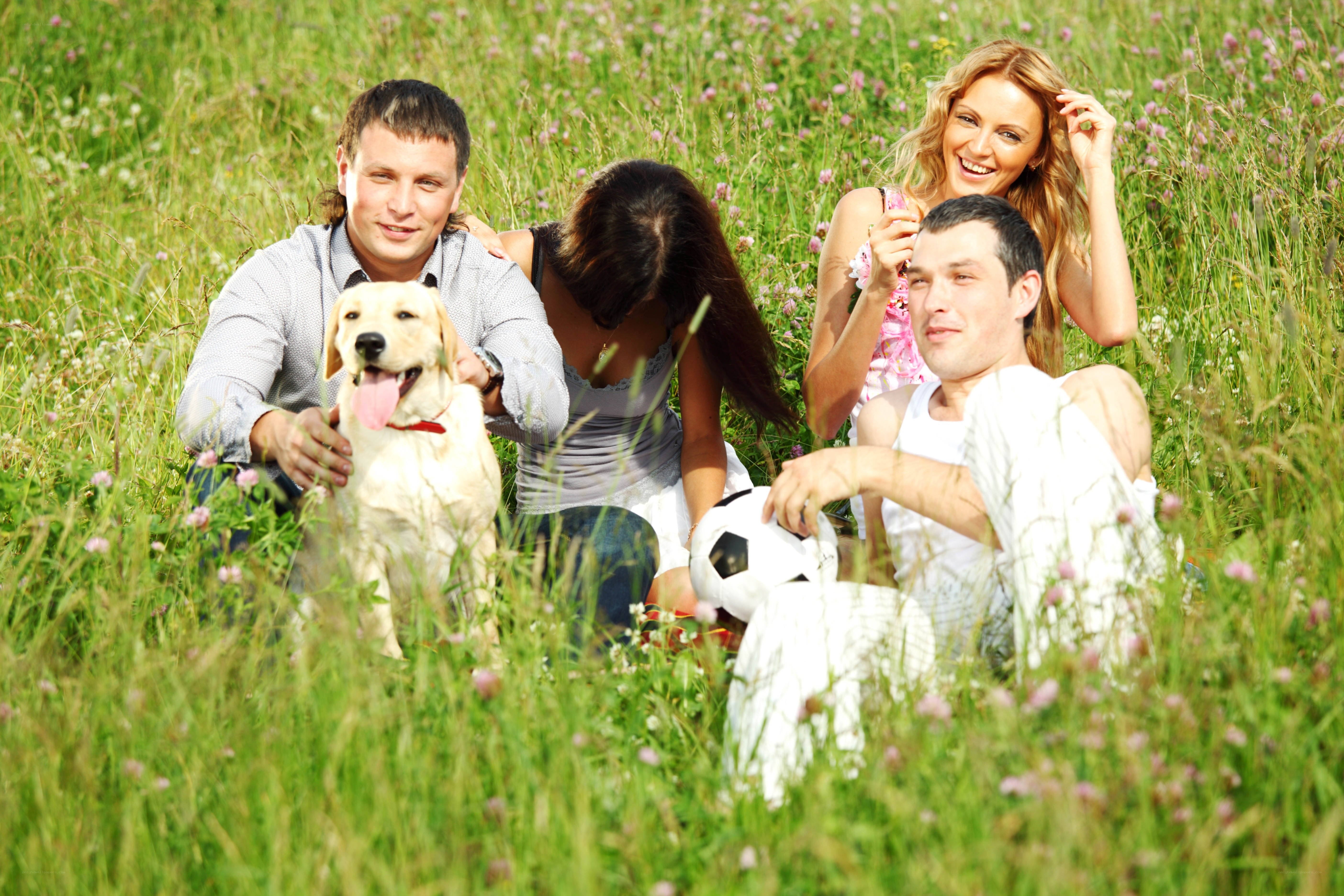 Friends and dog in a field