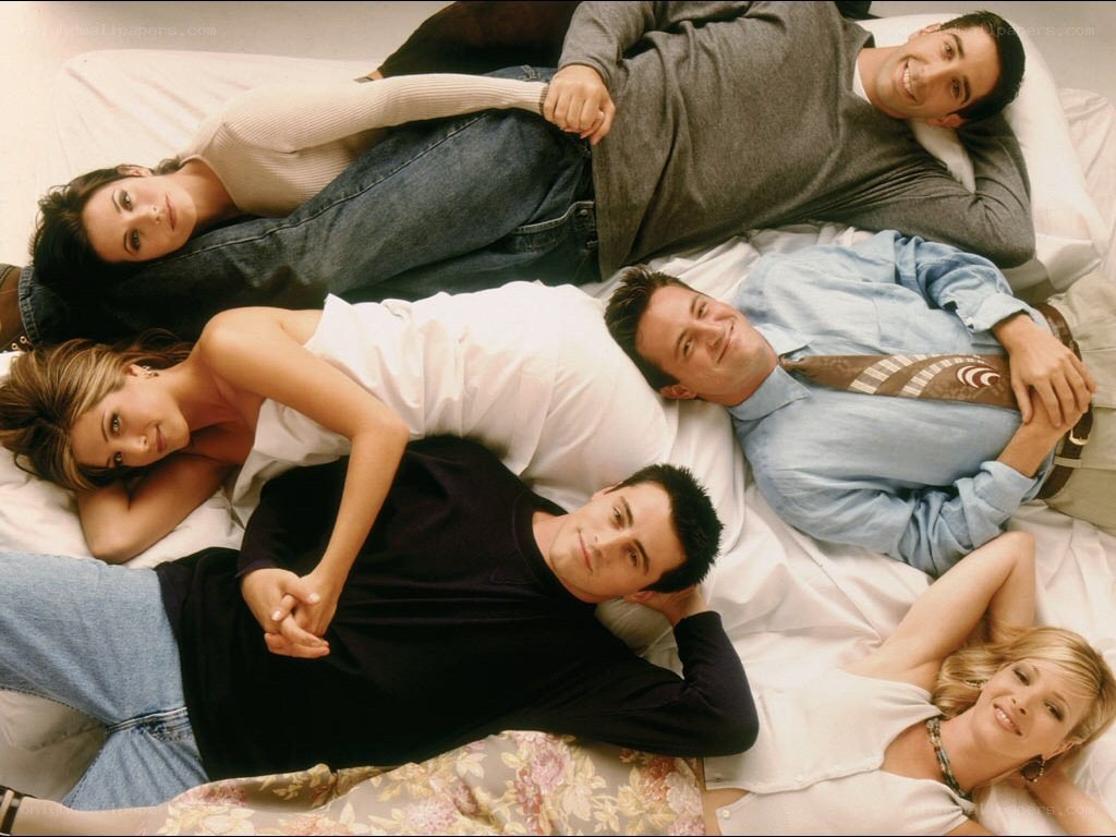 Friends cast on a bed