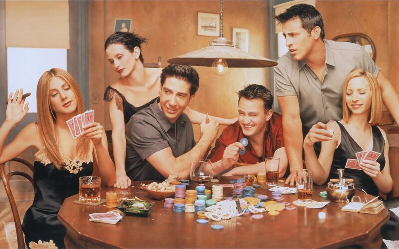 Friends cast playing cards