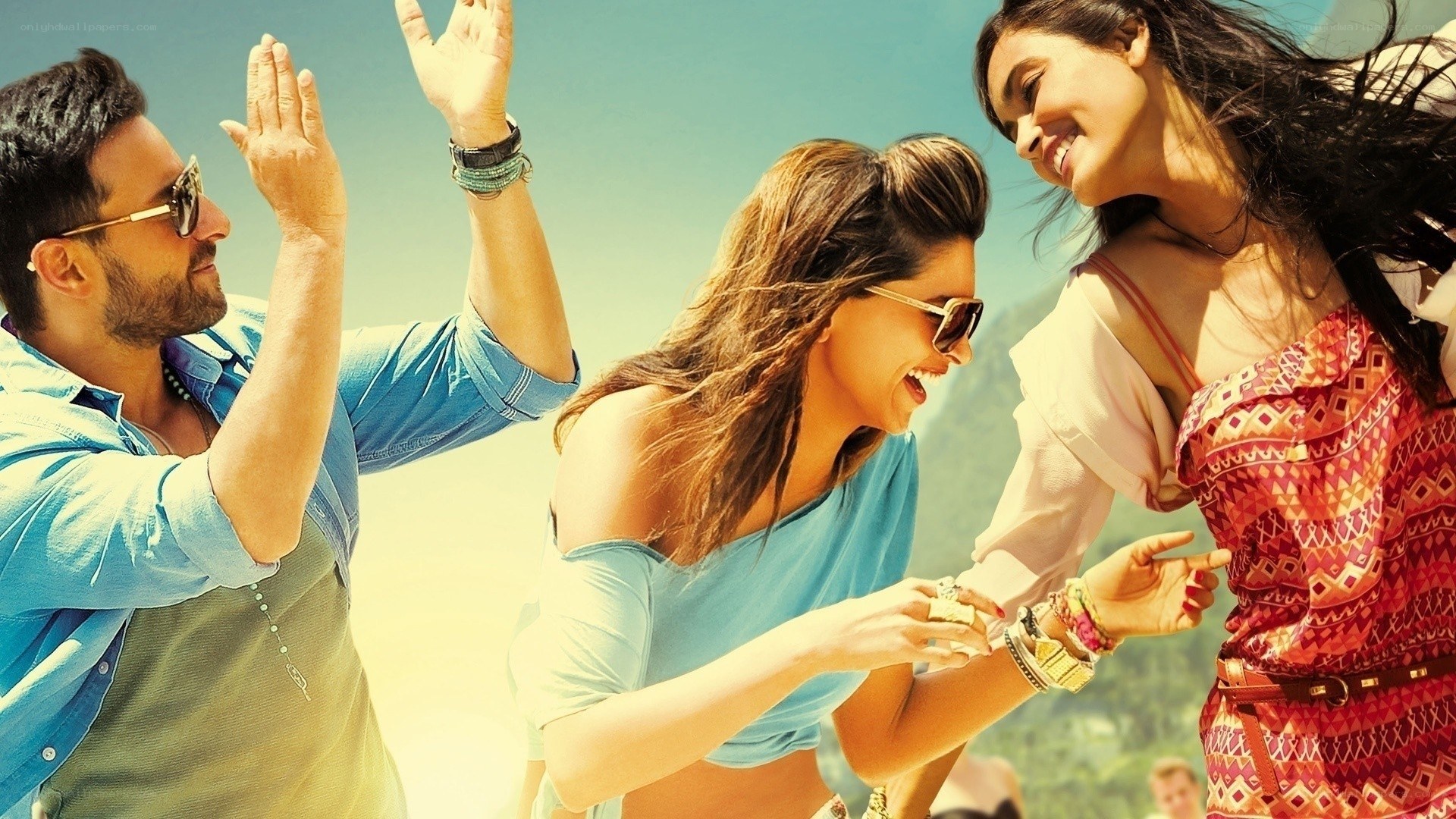 friends dancing on beach