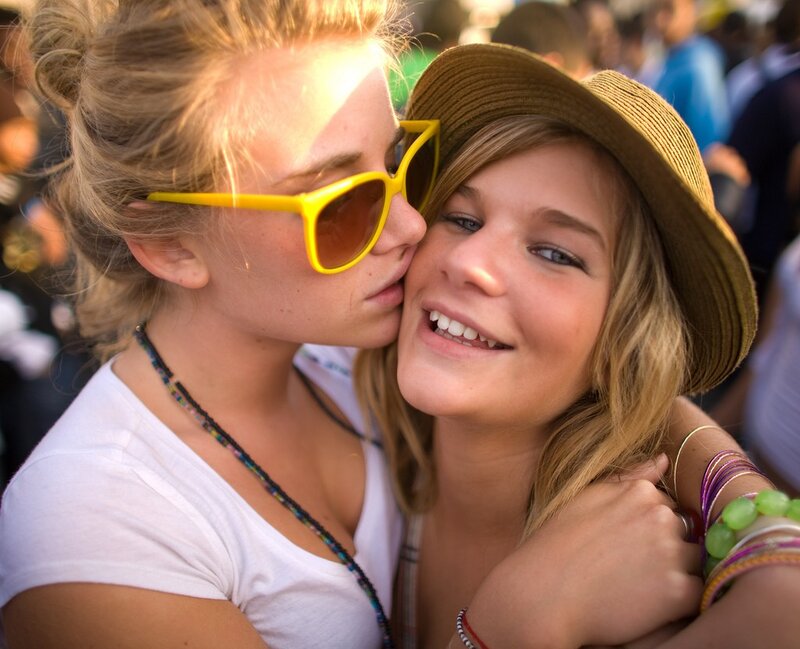 Friends embracing at a festival