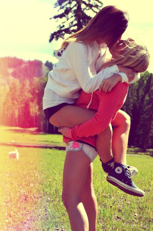 Friends hugging in a field