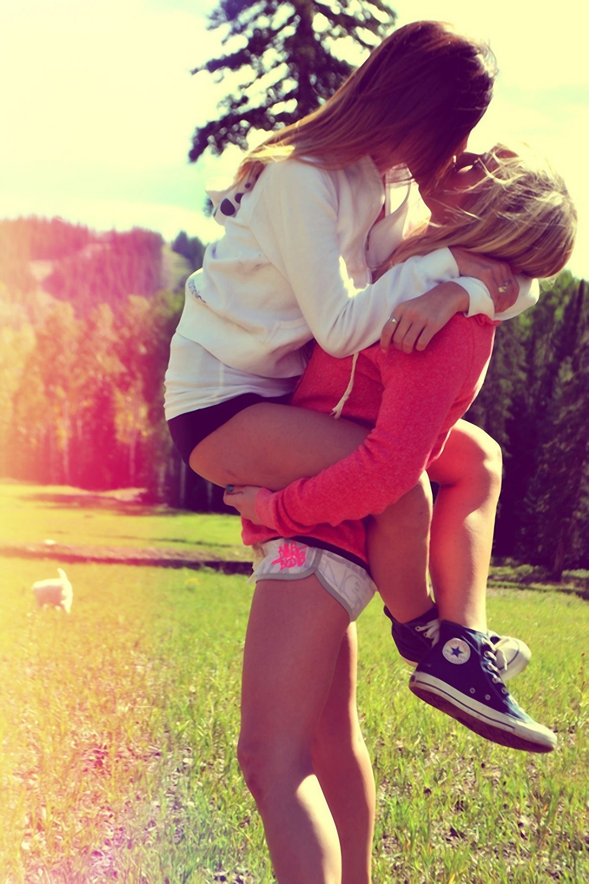 Friends hugging in a field