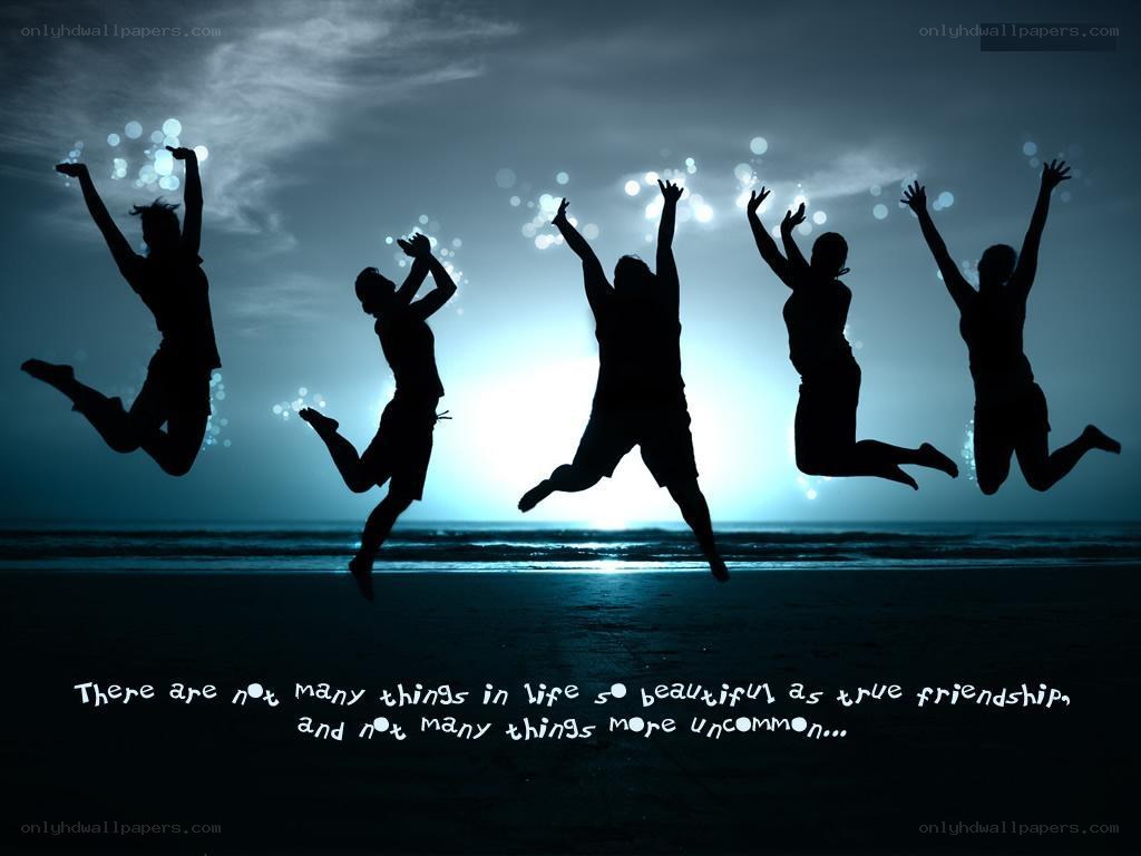 friends jumping on beach