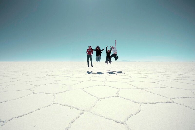 Friends jumping on salt flats