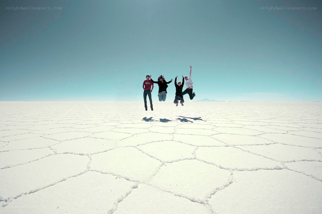 Friends jumping on salt flats
