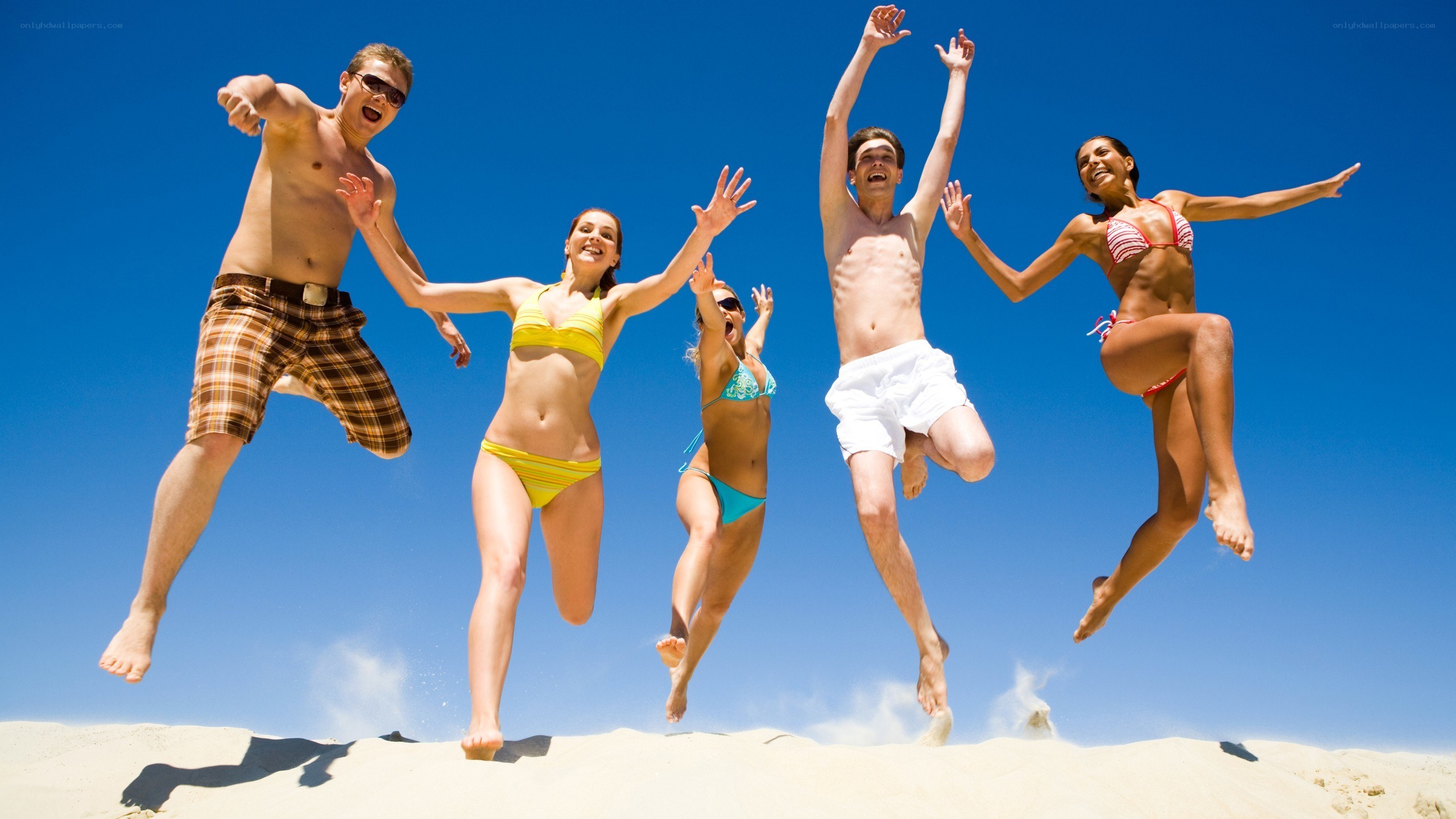 Friends jumping on the beach