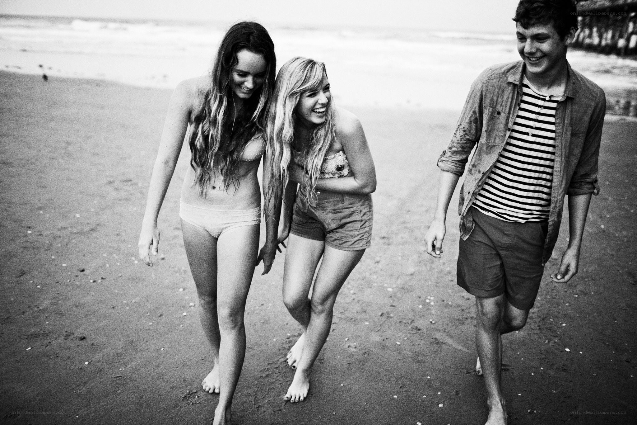 Friends laughing on the beach