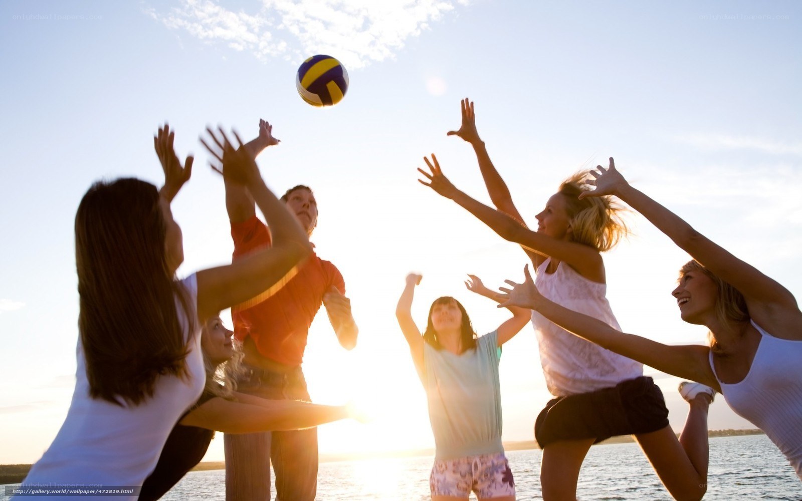 Friends playing beach volleyball