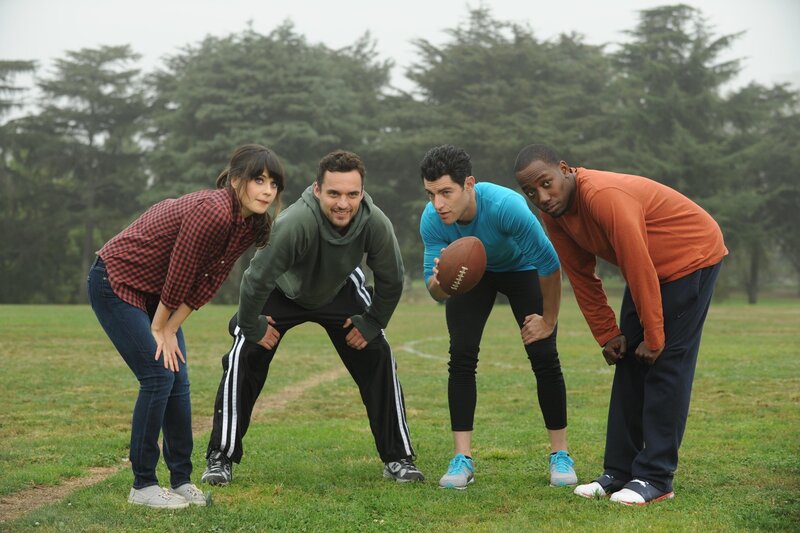 Friends playing football in a park