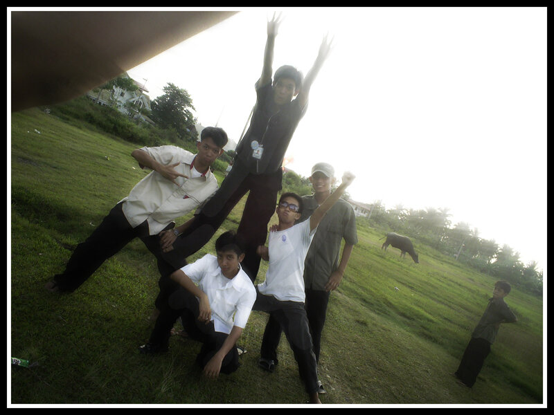 friends posing in a field