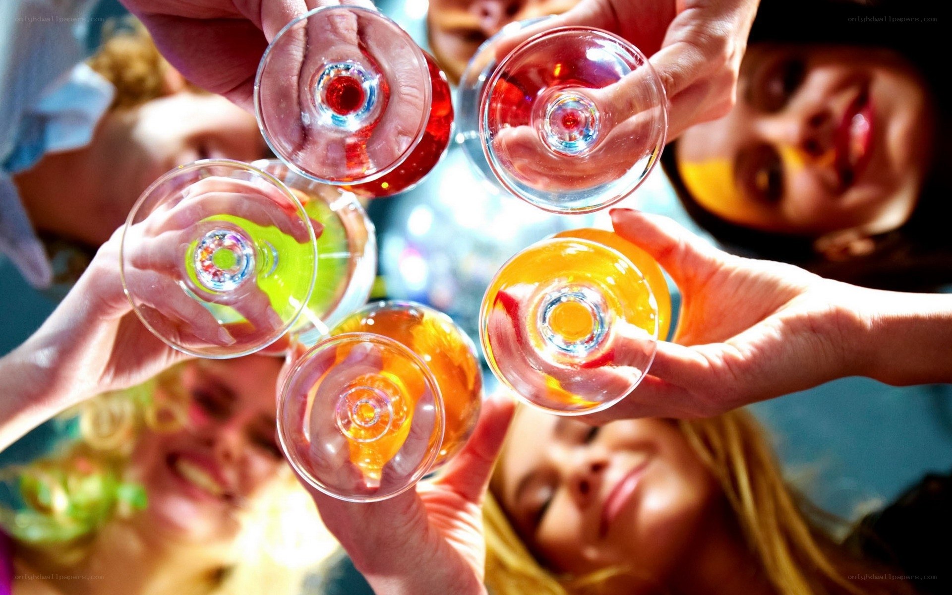 Friends toasting with colorful drinks