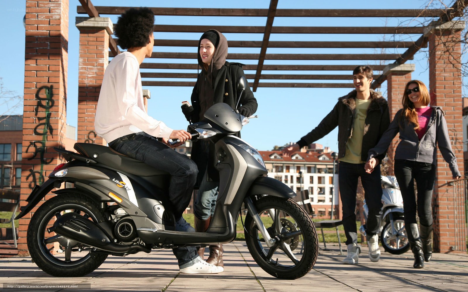 Friends with scooters in park
