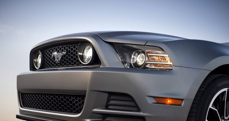 front of a silver mustang