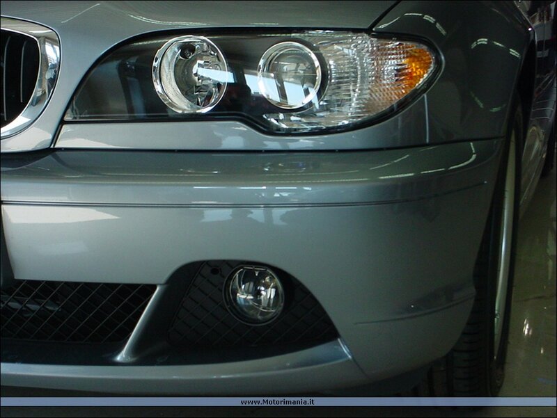 front of silver BMW car
