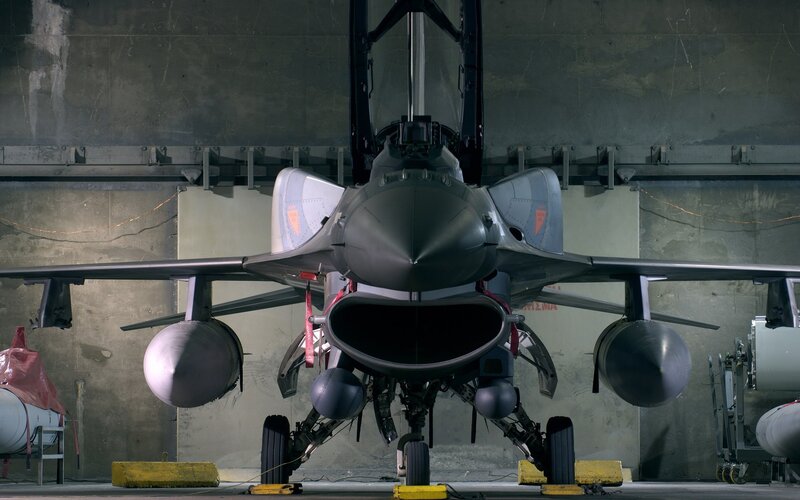Front view of fighter jet in hangar