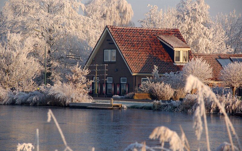 Frost-covered House by Water