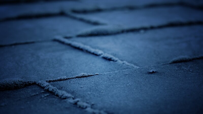 frost-covered pavement at night