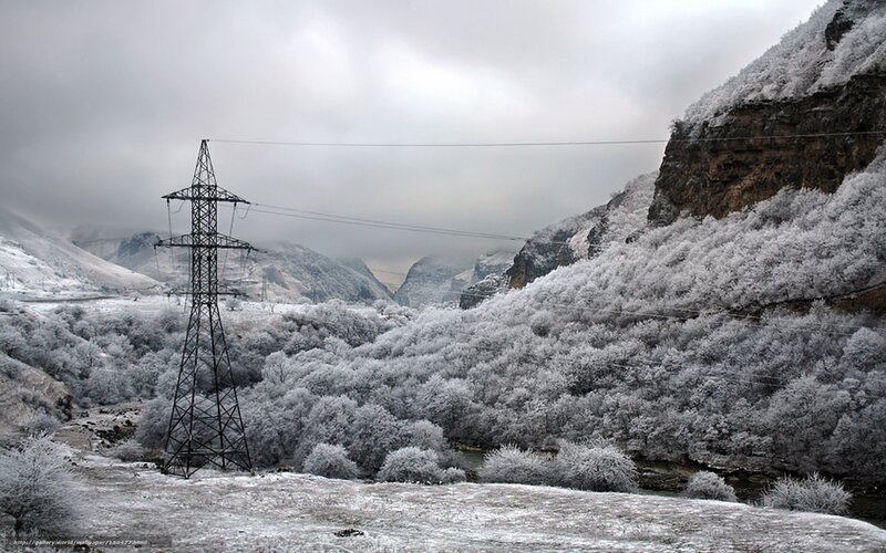 Frost-covered valley with power lines