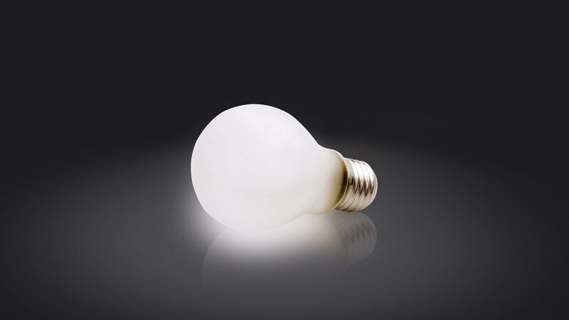 frosted light bulb on dark surface