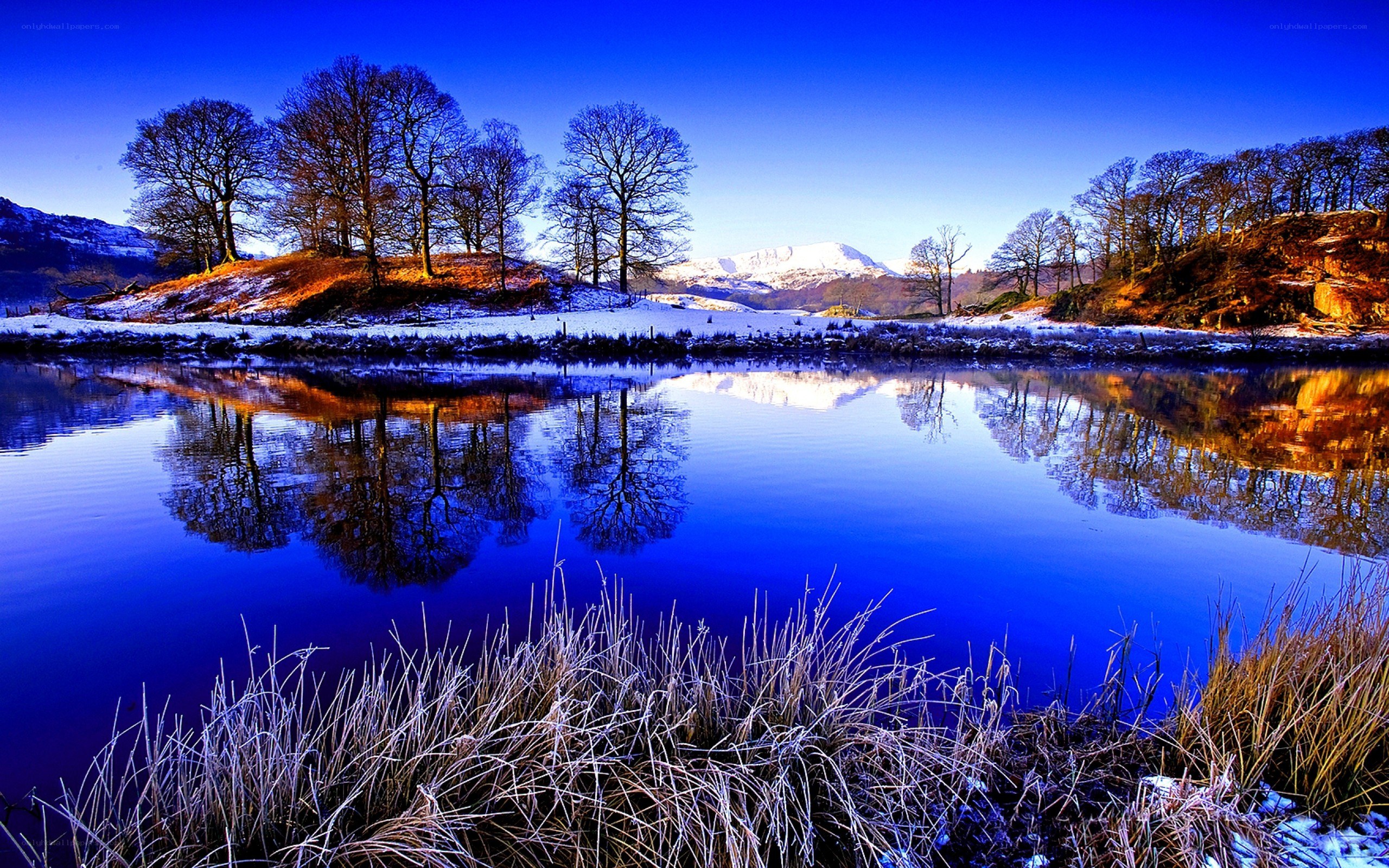 Frosty lake with mountain reflection