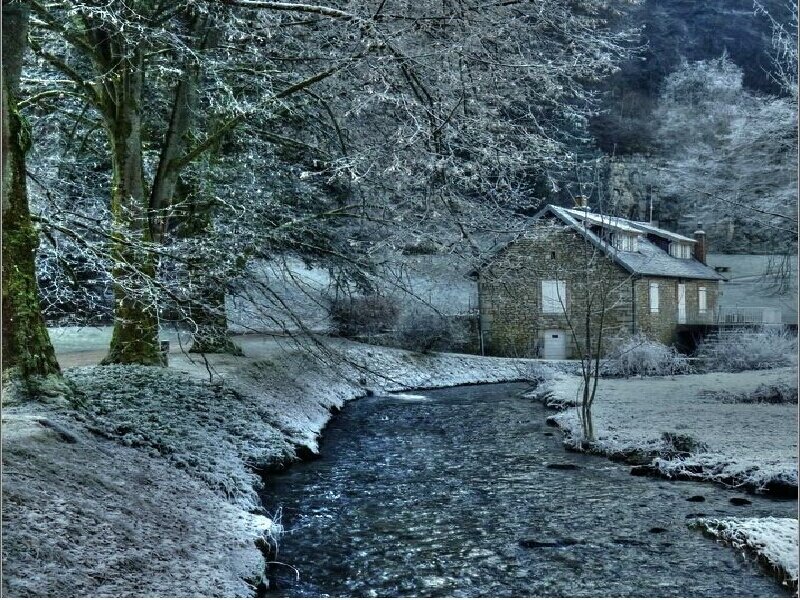 Frosty river scene with stone house