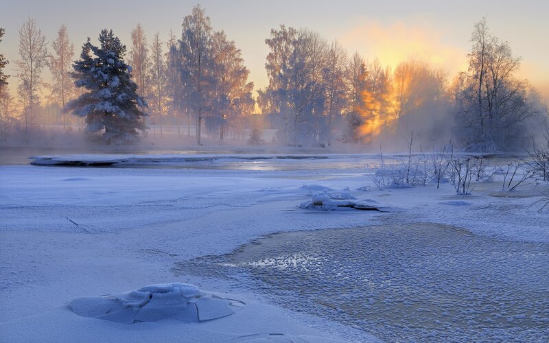 Frosty sunrise over a frozen river