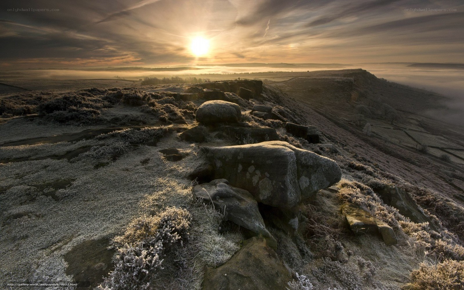 Frosty sunrise over rocky hills