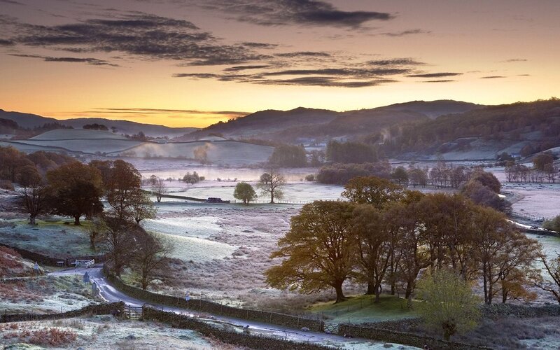 Frosty sunrise over rolling hills