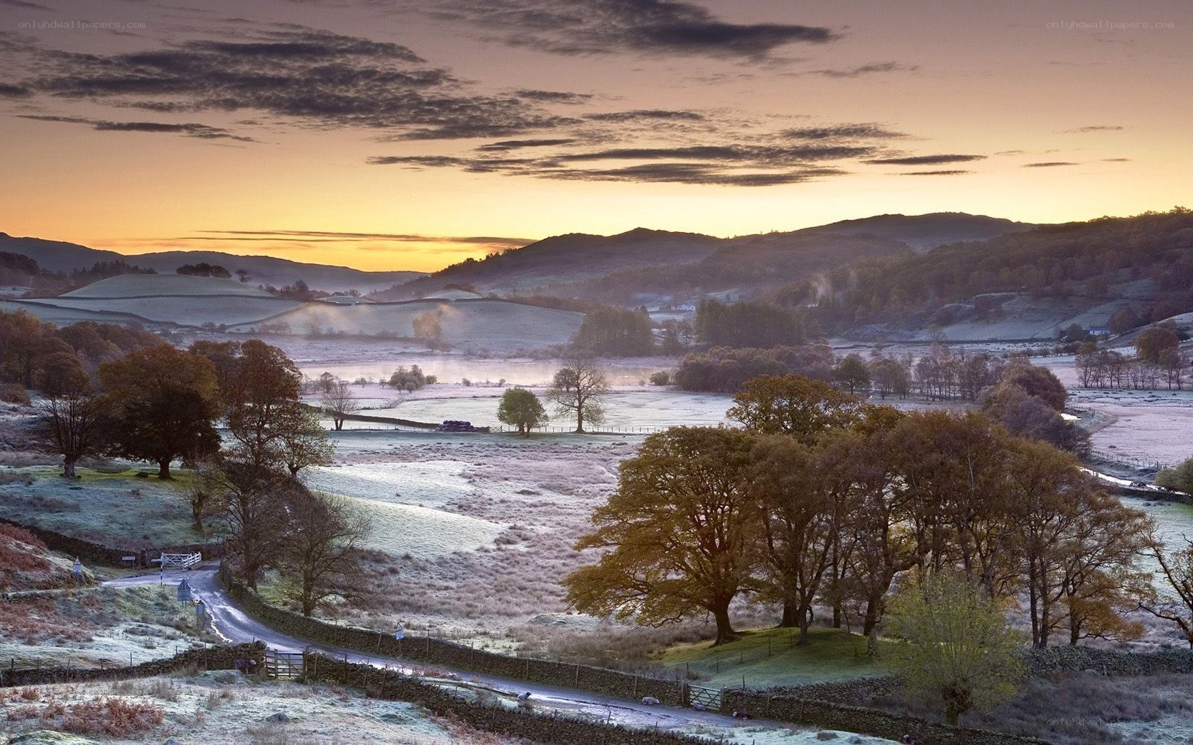 Frosty sunrise over rolling hills