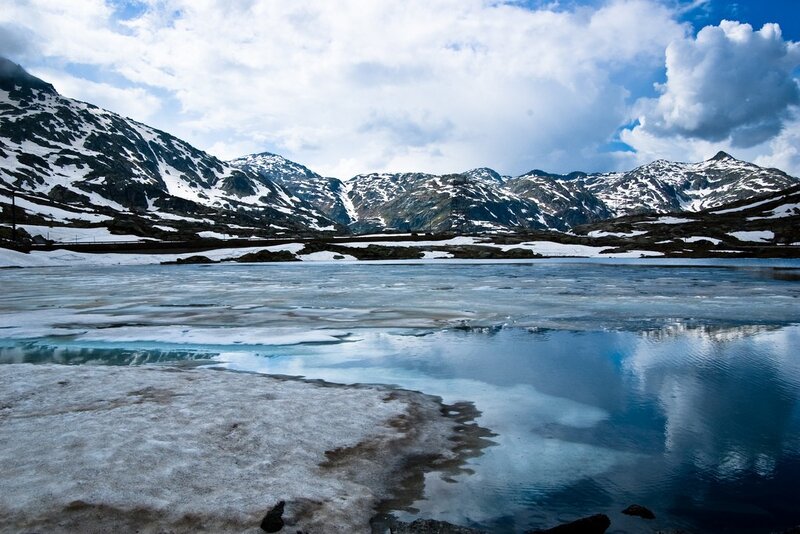 frozen alpine lake with snow-capped mountains