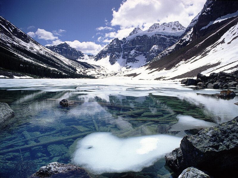 frozen alpine lake with snow-capped peaks