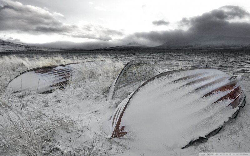 Frozen boats on a snowy shore
