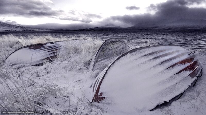 Frozen boats on a snowy shore