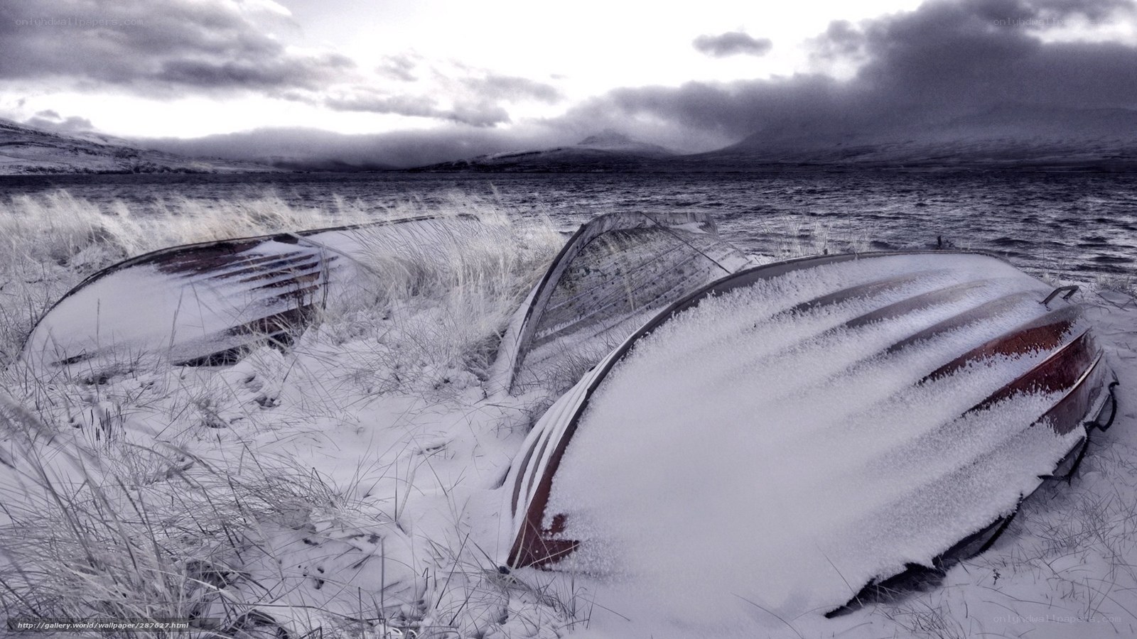 Frozen boats on a snowy shore