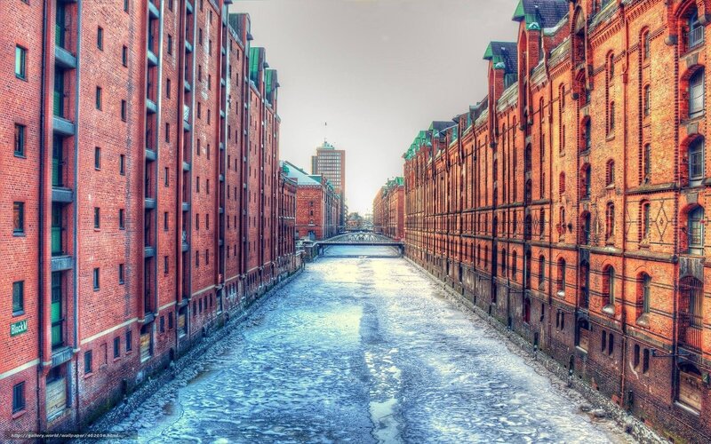 Frozen Canal Between Brick Buildings — Red