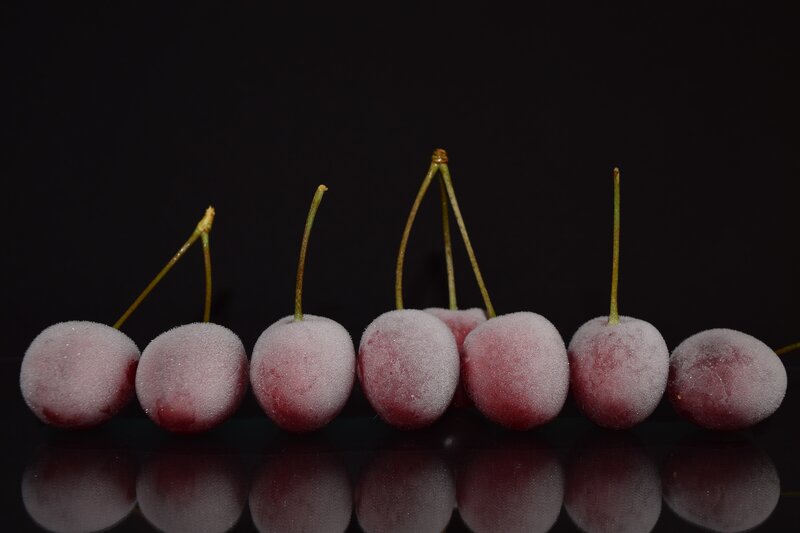 frozen cherries on black