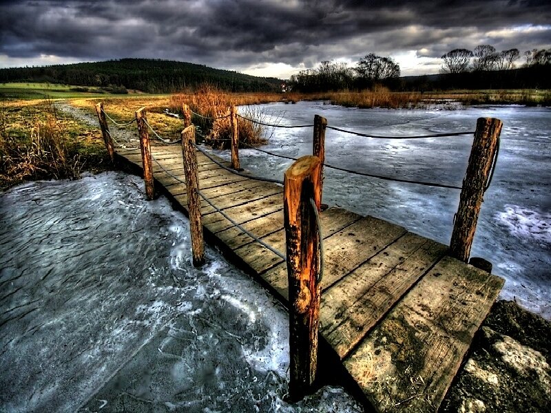 Frozen dock under stormy sky