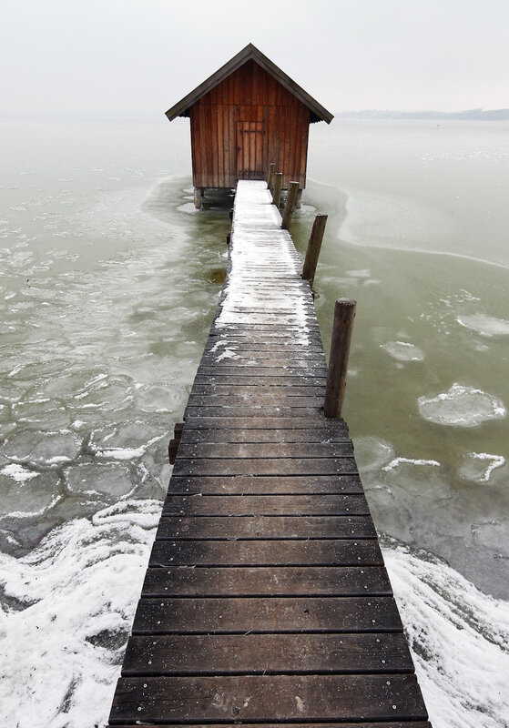 Frozen dock with boathouse
