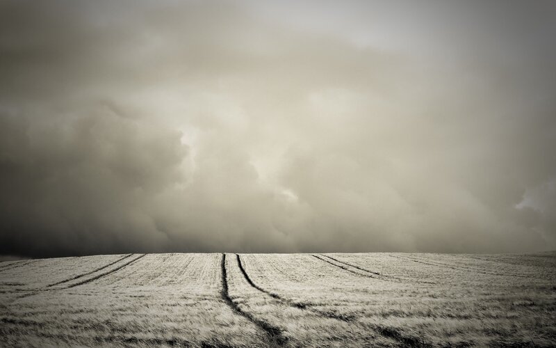 Frozen Field under Storm Clouds