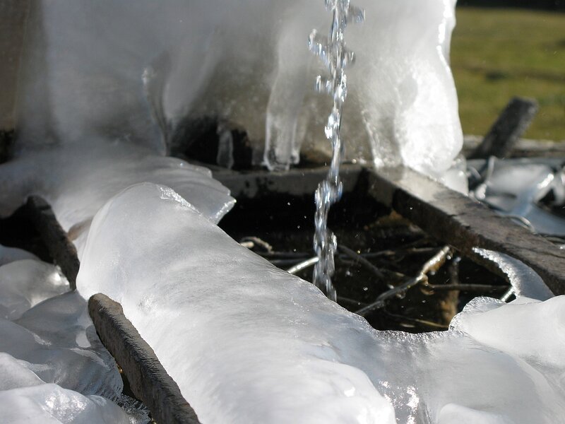 Frozen fountain with flowing water