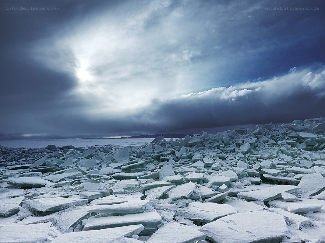 Frozen ice floes under stormy sky