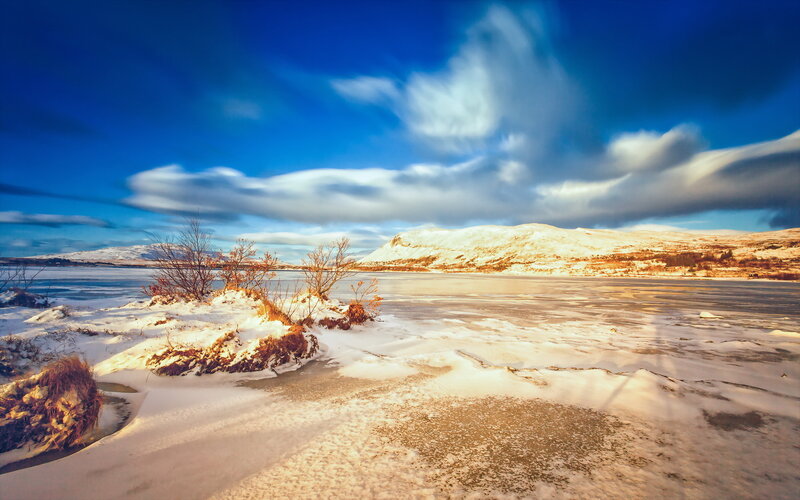 Frozen Lake and Snow-covered Hills