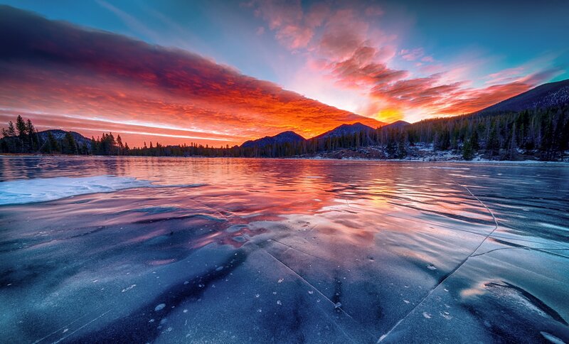 Frozen Lake at Sunset — Orange, Dramatic, Photograph, Mountains, Trees, Sky