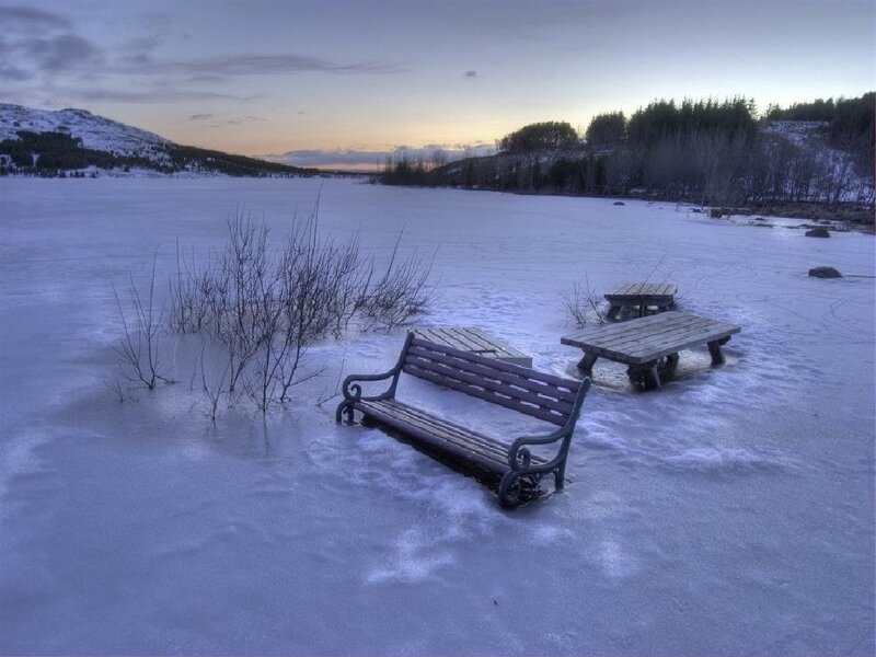Frozen lake bench at dusk
