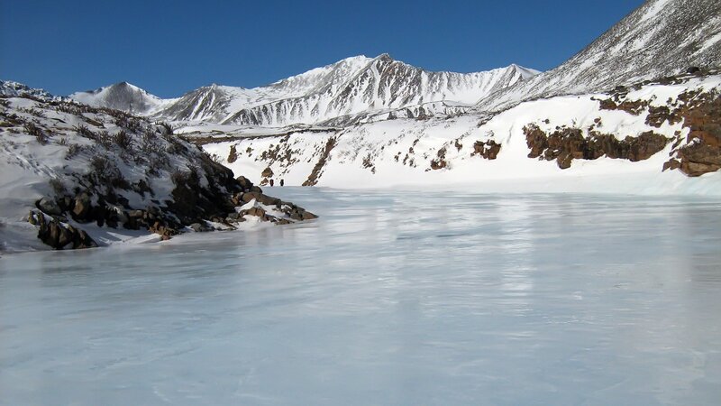 Frozen Lake in Mountains — Blue, Serene, Winter, Photograph, Snow, Sky, Rocks