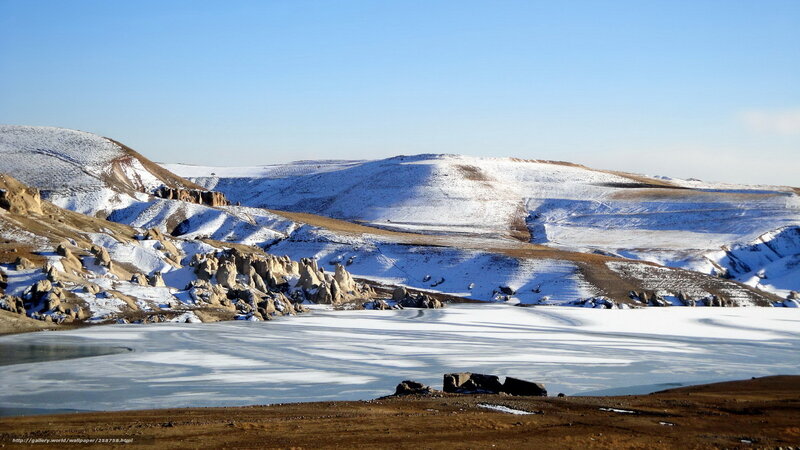 Frozen lake in snowy landscape