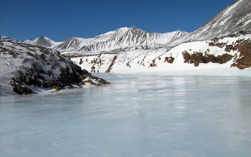 frozen lake in snowy mountains